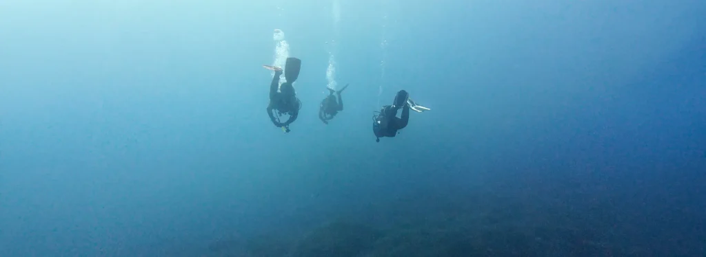 Group of Divers in the north of Menorca, Spain