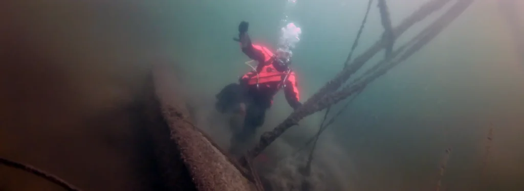 Chris and the wreck of a sailboat at Lake Starnberg, Bavaria, Germany